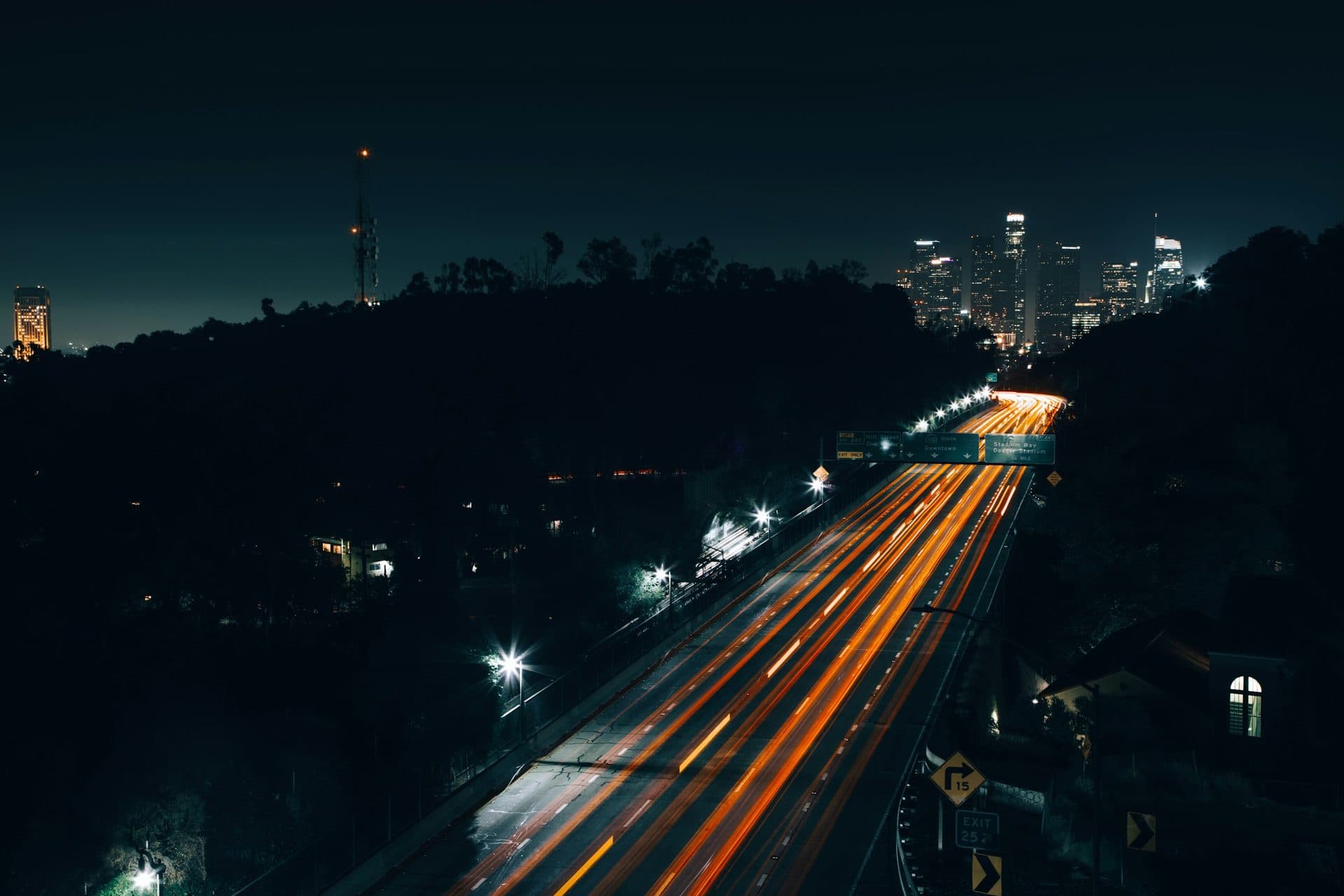 Light trails on the 110 freeway leading toward the downtown Los Angeles skyline at night