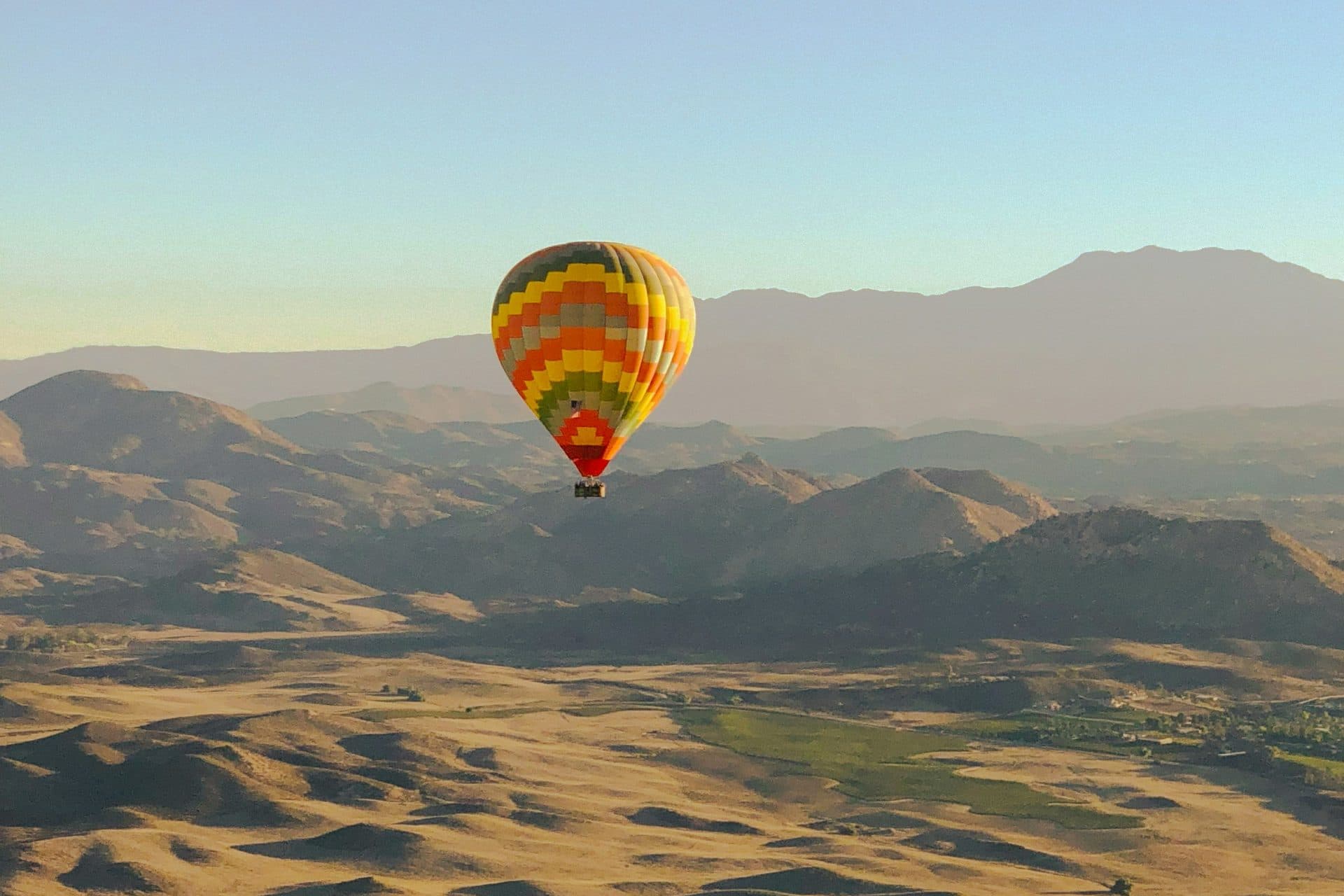 Hot air balloon floating over the hills of the Temecula Valley